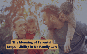 A smiling family of four outdoors, with parents carrying children on their backs, representing the meaning of parental responsibility in UK family law.