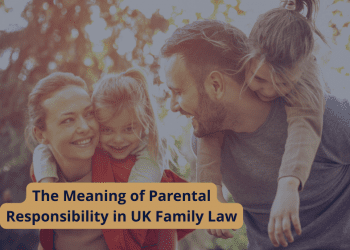 parental-responsibility A smiling family of four outdoors, with parents carrying children on their backs, representing the meaning of parental responsibility in UK family law.